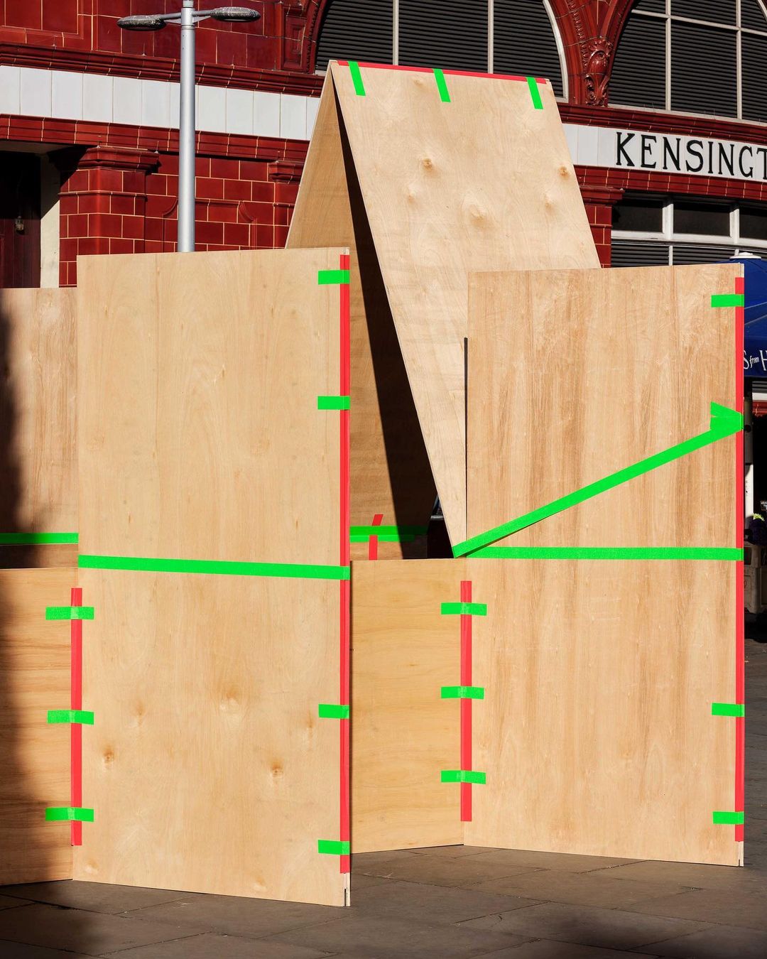 Plywood installation using fluorescent tape to hold sections together.