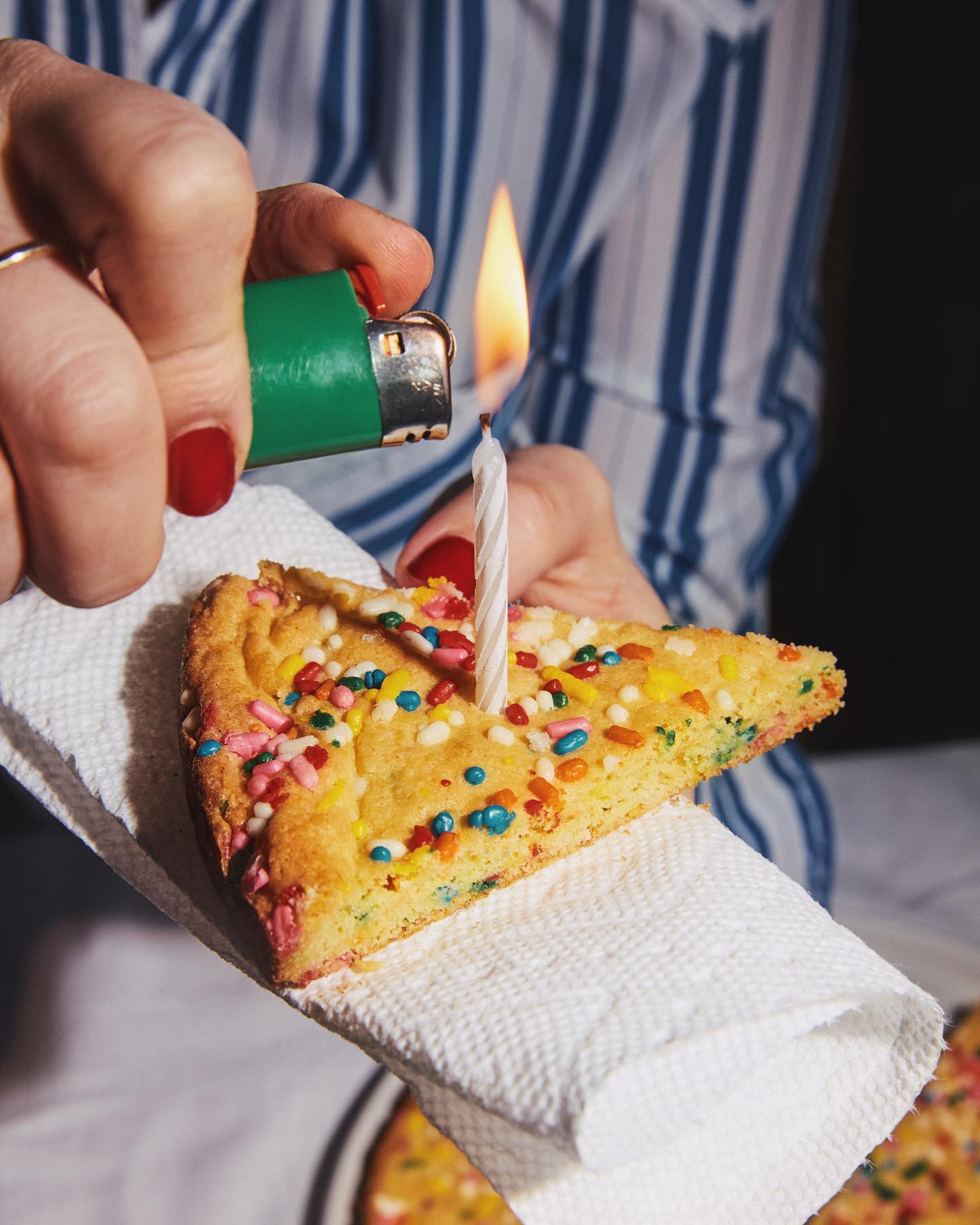 Slice of a cookie with a celebration candle in middle