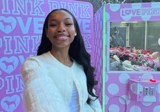 Teen Influencer takes selfie at Victoria's Secret event in front of game